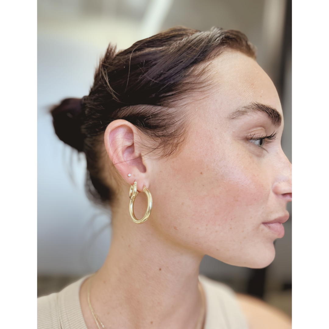 woman with diamond earrings accented with hoops