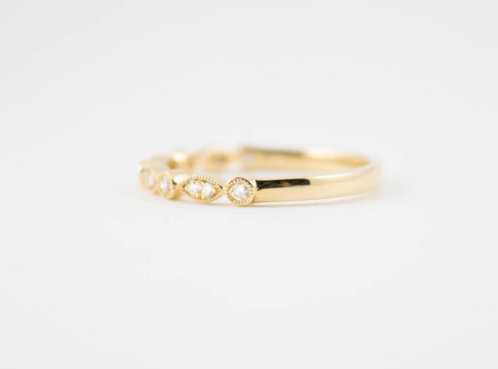 side view of yellow gold ring with diamonds